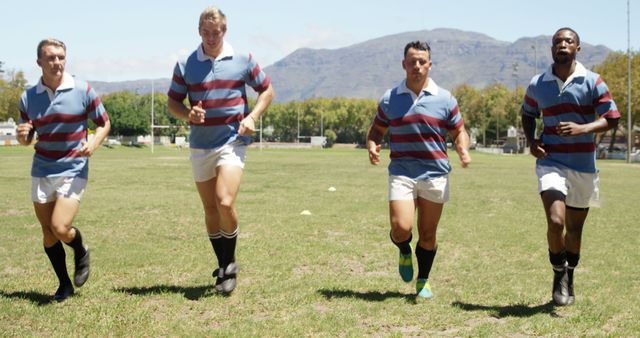 Rugby Team Players Warming up on Field under Sunny Day Mountains in Background - Download Free Stock Images Pikwizard.com