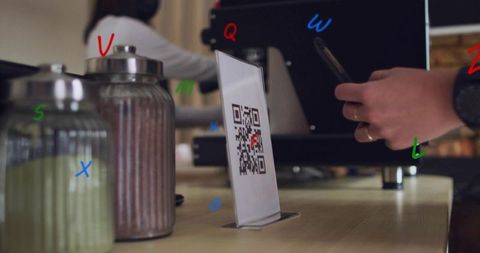 Customer scanning qr code for contactless payment at coffee counter with espresso machine