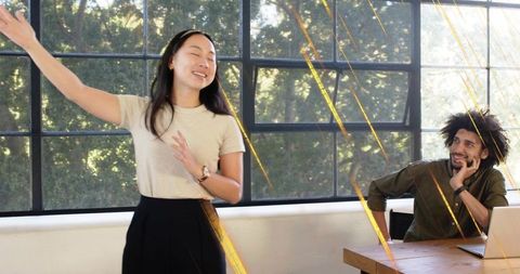 Presenting in Sunlit Coworking Space, Collaborating for Productivity and Team Connection