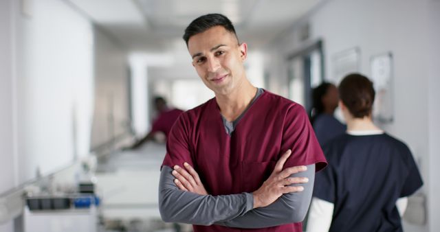 Confident Male Nurse in Hospital Corridor with Medical Staff - Download Free Stock Images Pikwizard.com