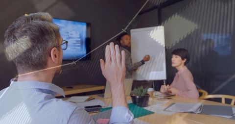 Business Team Collaborating in Conference Room with Flip Chart