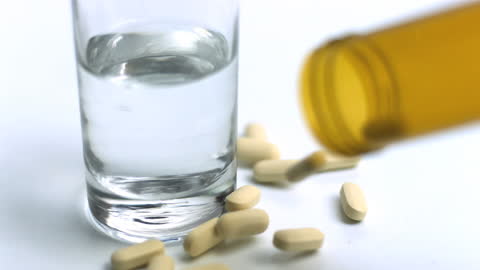 Pills and Glass of Water in Motion