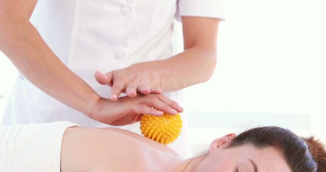 Female Masseuse Treating Client with Massage Ball in Spa - Download Free Stock Images Pikwizard.com