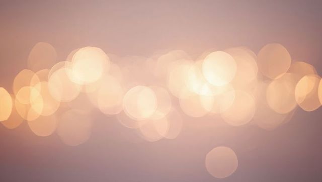 Pastel bokeh lights creating soft horizontal glow for backgrounds and web design