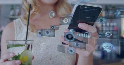 Blonde woman holding smartphone and cocktail viewing holographic ar interface at bar