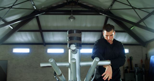 Man Practicing Martial Arts with Training Equipment in Gym - Download Free Stock Images Pikwizard.com