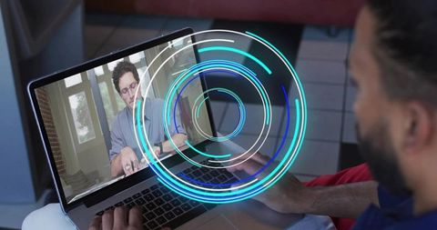 Man connecting via laptop for remote collaboration with blue holographic interface