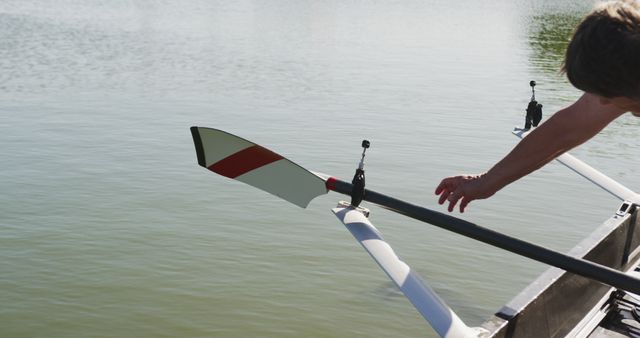 Person Adjusting Oar on Boat in Calm Water - Download Free Stock Images Pikwizard.com