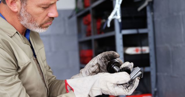 Mechanic Inspecting Gears with Gloves in Workshop - Download Free Stock Images Pikwizard.com