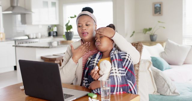 Concerned Mother Caring for Sick Child During Online Consultation - Download Free Stock Images Pikwizard.com