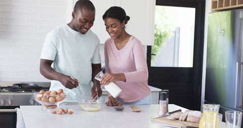 Joyful Couple Preparing Breakfast in Modern Kitchen