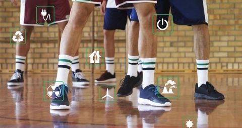 Standing athletes wearing striped socks on gym court with green energy icons and teamwork vibe