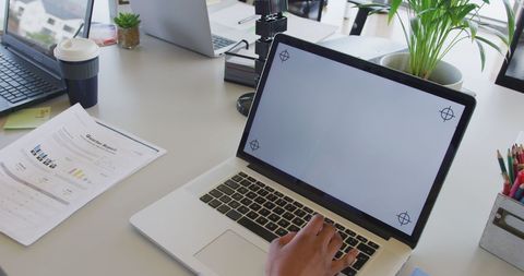 Businesswoman Reviewing Report with Laptop on Office Desk - Download Free Stock Images Pikwizard.com