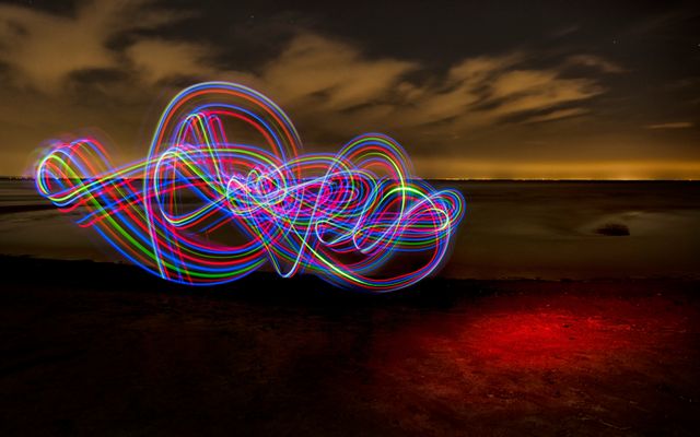 Colorful Light Trails Over Dark Beach at Night - Download Free Stock Photos Pikwizard.com