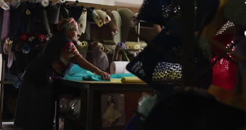 Craftsman Processing Fabric in Artisan Workshop