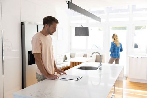 Couple Reviewing Documents at Modern Kitchen Island