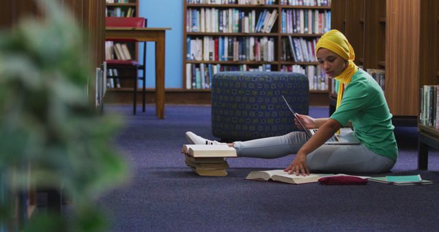 Dedicated Student Studying in Library with Focused Expression - Download Free Stock Images Pikwizard.com