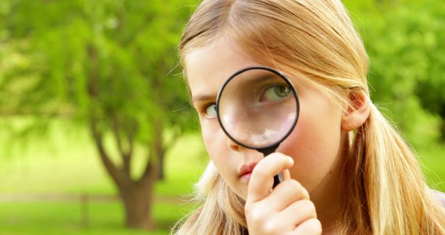 Curious Young Girl Exploring Nature with Magnifying Glass in Park - Download Free Stock Images Pikwizard.com