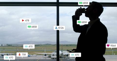 Businessman in Airport with Smartphone and Social Media Notifications