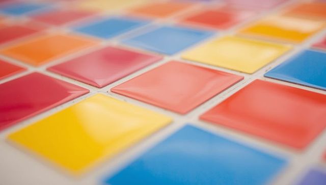 Glossy square color swatches on white surface in vibrant palette