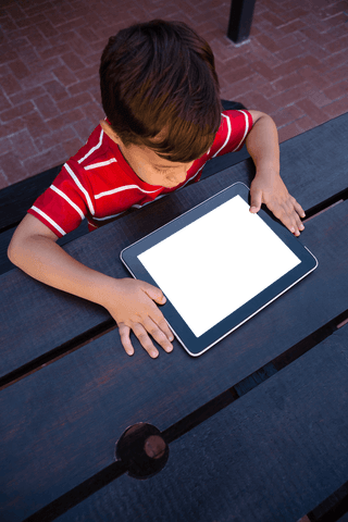 Transparent Screen Tablet with Boy Engaged Outdoors