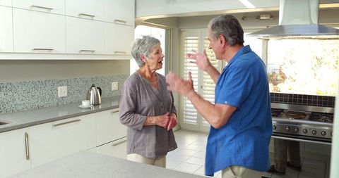 Senior couple arguing in modern kitchen