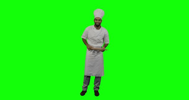 Professional chef standing and holding a rolling pin against a green screen background. Perfect for use in culinary tutorials, recipe blogs, cooking videos, and promotional content. The green screen makes it easy to replace the background with any kitchen or restaurant setting.