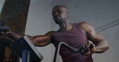 Focused Man Cycling Indoors in Maroon Tank Top Enhancing Fitness