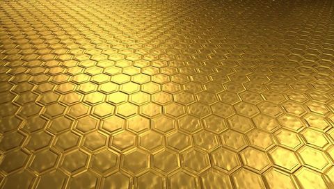 Glowing golden honeycomb metal surface tilting with embossed hex pattern and bevels