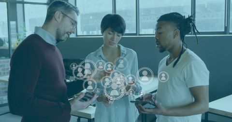 Diverse professionals discussing data with digital overlay in modern office