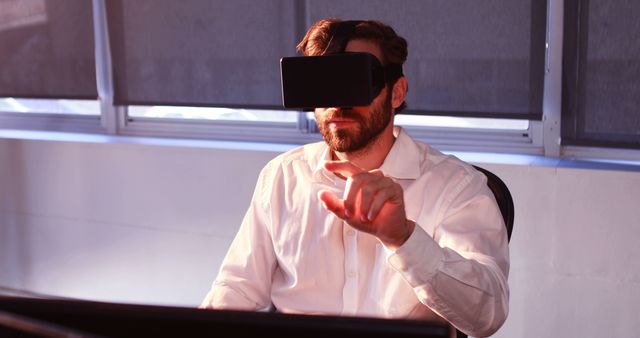 Businessman using virtual reality headset in office setup - Download Free Stock Images Pikwizard.com