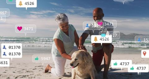 Petting golden retriever on beach while checking smartphone with social media overlays
