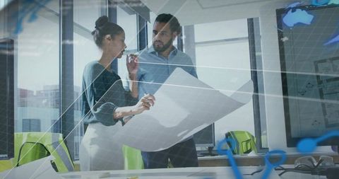 Architects Analyzing Blueprints in Modern Office with Technological Elements