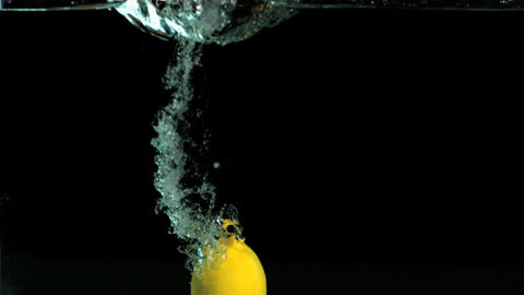 Lemon Splashing into Water with Dramatic Slow Motion Effect