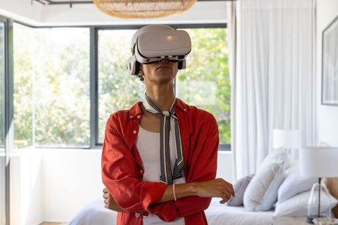 Man experiencing virtual reality in modern bedroom