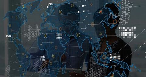 Business analysts pointing at glowing world map overlay reviewing global data trends