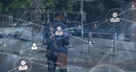 Digital network overlay on businessman walking in urban area