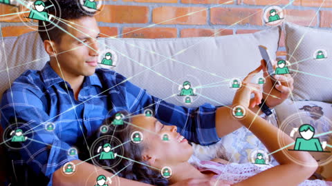 Diverse Couple Using Smartphone with Social Media Interface Overlay