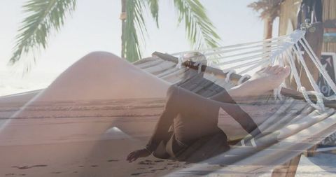 Tropical Retreat: Woman Relaxes in Hammock by Blue Ocean