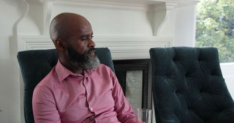 Man relaxing in elegant living room with a drink