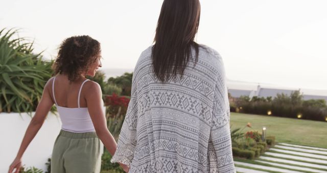 Women Holding Hands in Serene Outdoor Garden - Download Free Stock Images Pikwizard.com