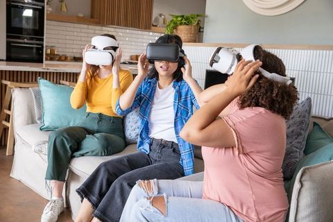 Diverse Women Enjoying Virtual Reality on Cozy Couch