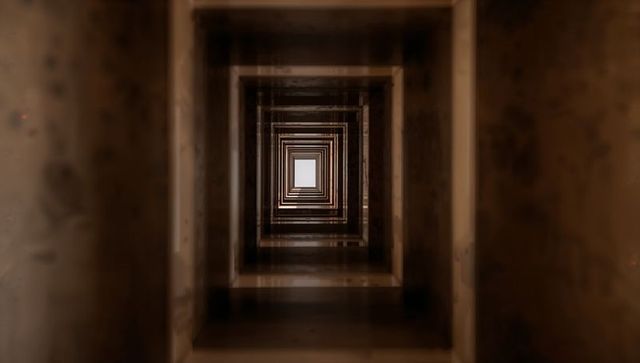 Repeating Bronze Square Frames Leading Eye Down Infinite Corridor Toward Central Light