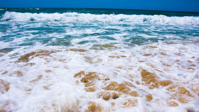 Waves crashing on sandy beach - Download Free Stock Photos Pikwizard.com