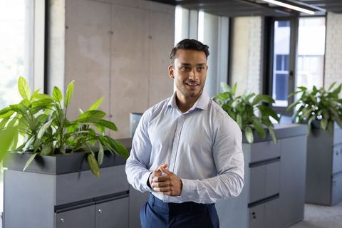 Confident professional in modern office with stylish planters