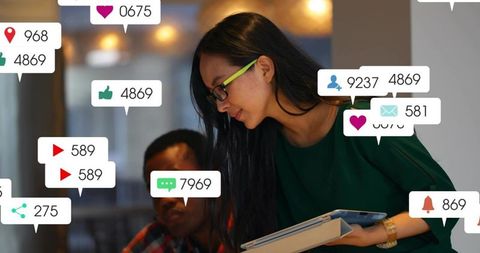 Leaning colleague holding tablet and folders with social media notification icons floating