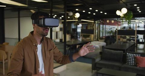 Young Adult Man Exploring Virtual Reality in Coworking Space