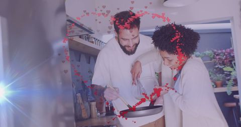 Romantic interracial couple cooking at home together