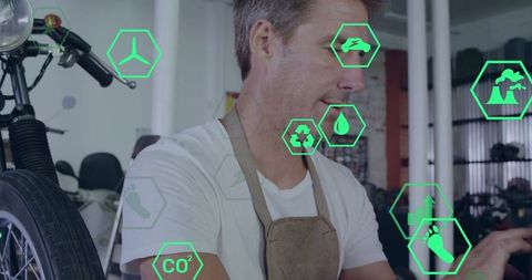 Mechanic repairing motorcycle wheel with augmented reality overlays in industrial garage