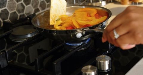 Cooking Vegetables on Gas Stove with Spatula